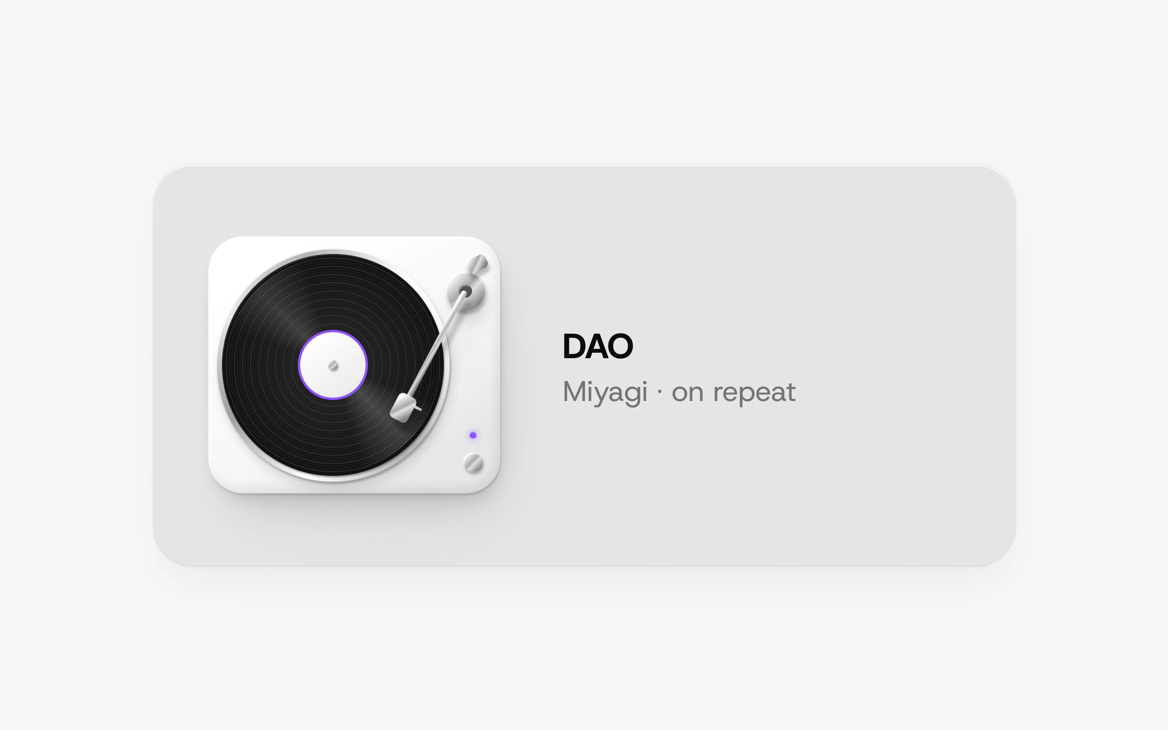 A porcelain desk card with a white turntable playing a black record, beside the line: DAO, Miyagi, on repeat.